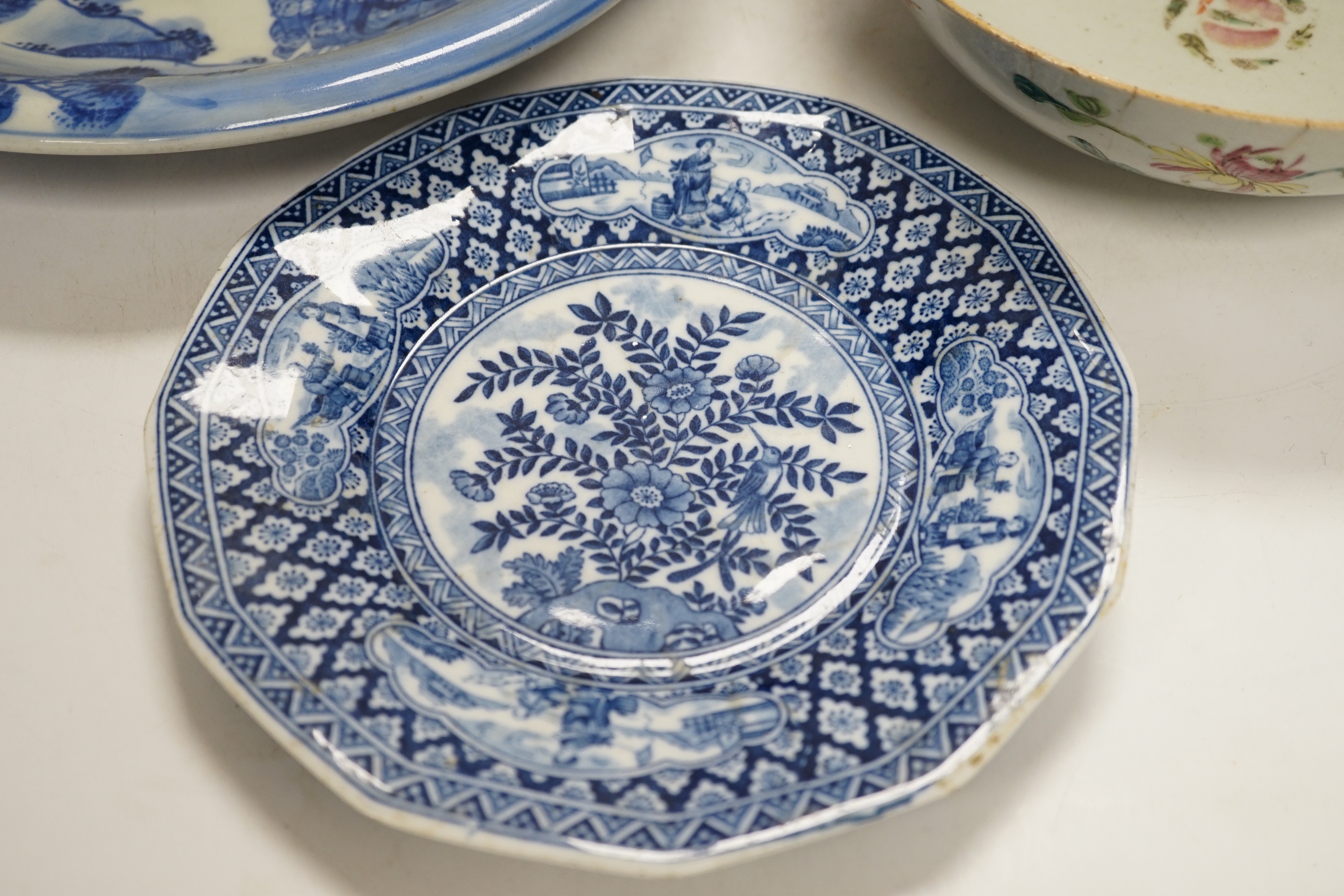 Assorted Chinese and Japanese ceramics comprising a famille rose bowl, two blue and white plates and a blue and white bowl, largest 30cm in diameter